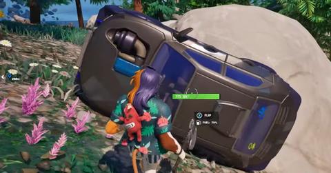 A player trying to flip a vehicle in Fortnite.