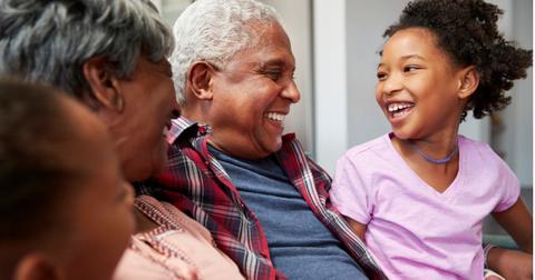 grandparents-relaxing-on-sofa-at-home-with-granddaughters-picture-id992107562-1558539493897.jpg