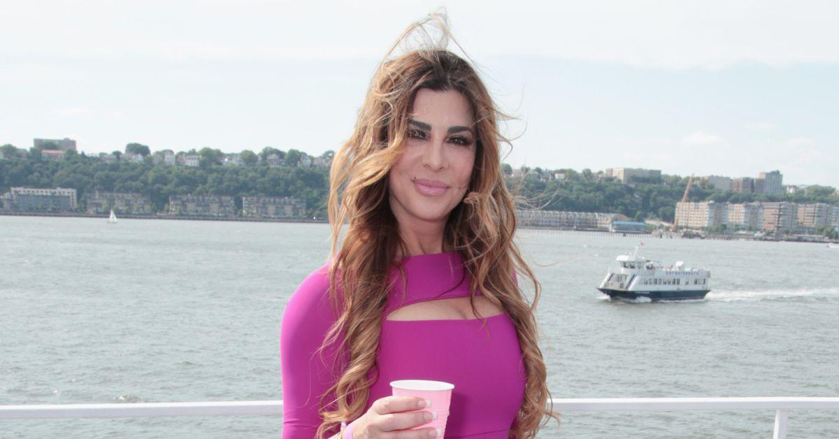 Siggy Flicker holding a drink on a boat