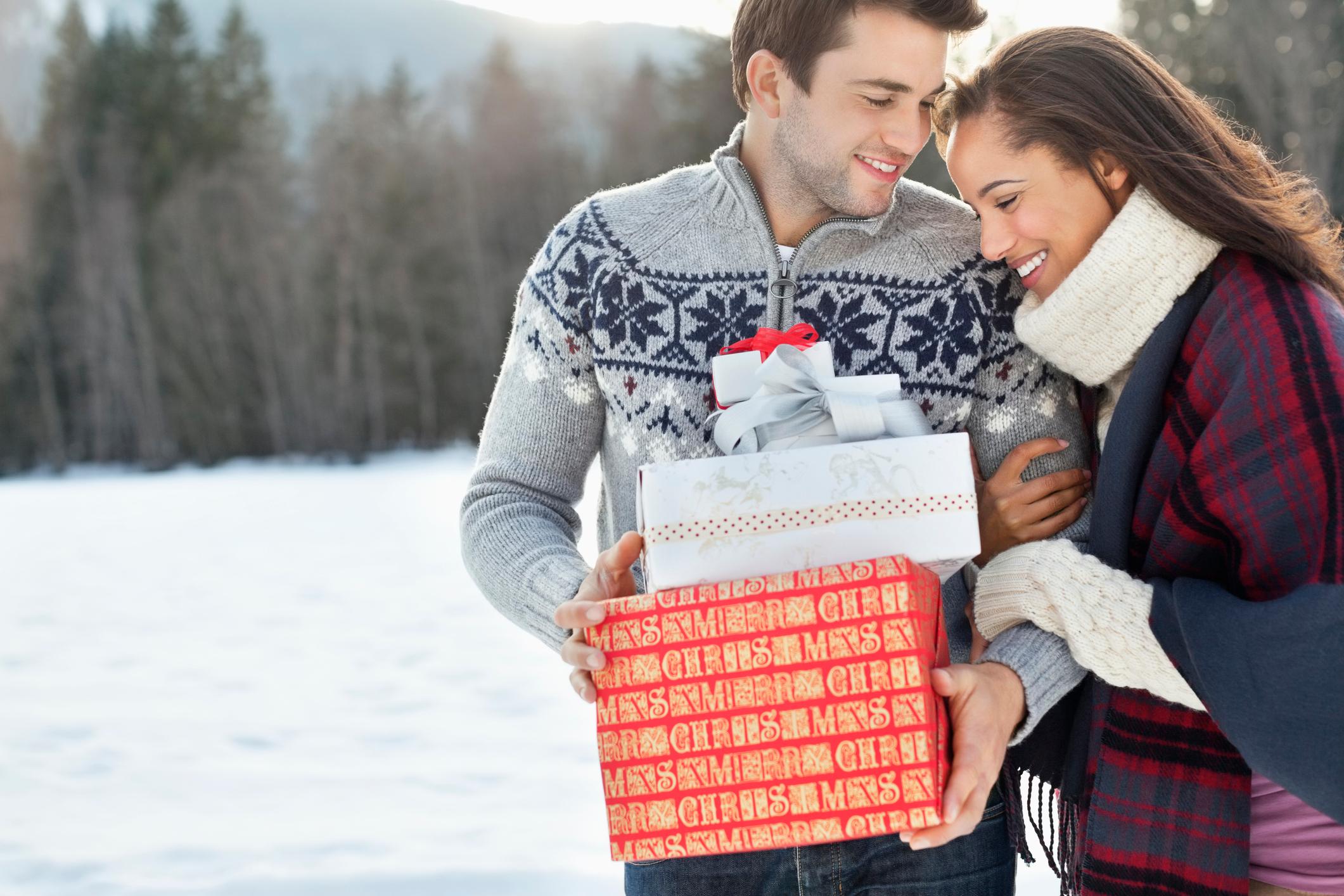 couple holding gifts outside