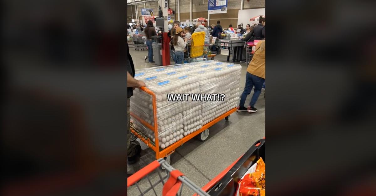 Costco shopper has entire flat bed cart full with egg cartons.