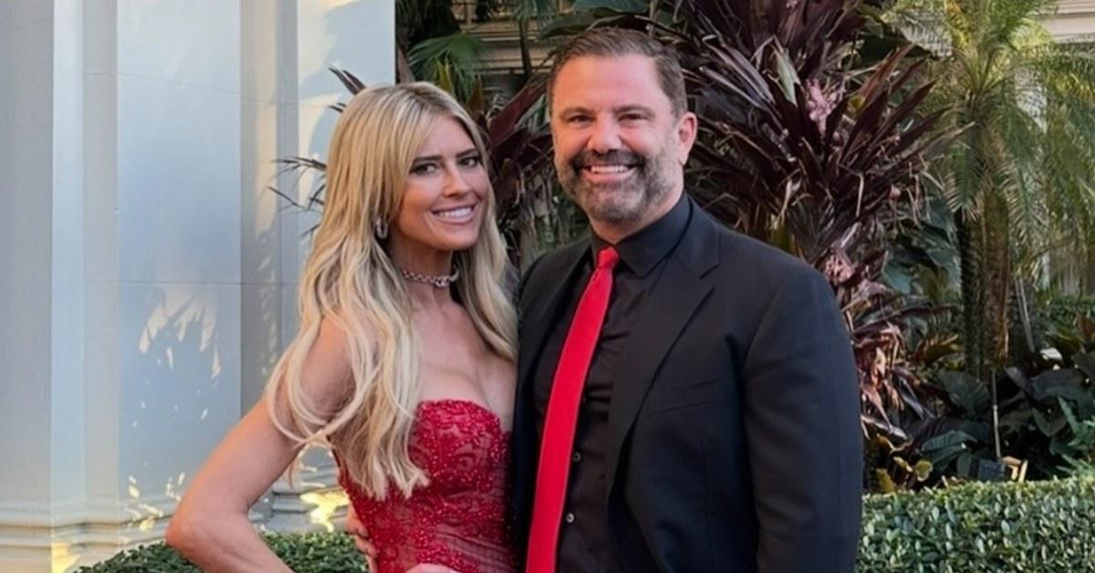 Christina Haack wearing a red dress alongside her boyfriend, Christopher Larocca.