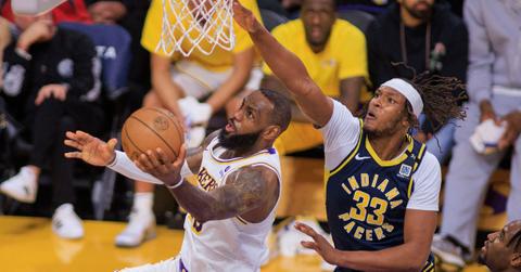 LA Lakers LeBron James attempts to score past Indiana Pacers Myles Turner