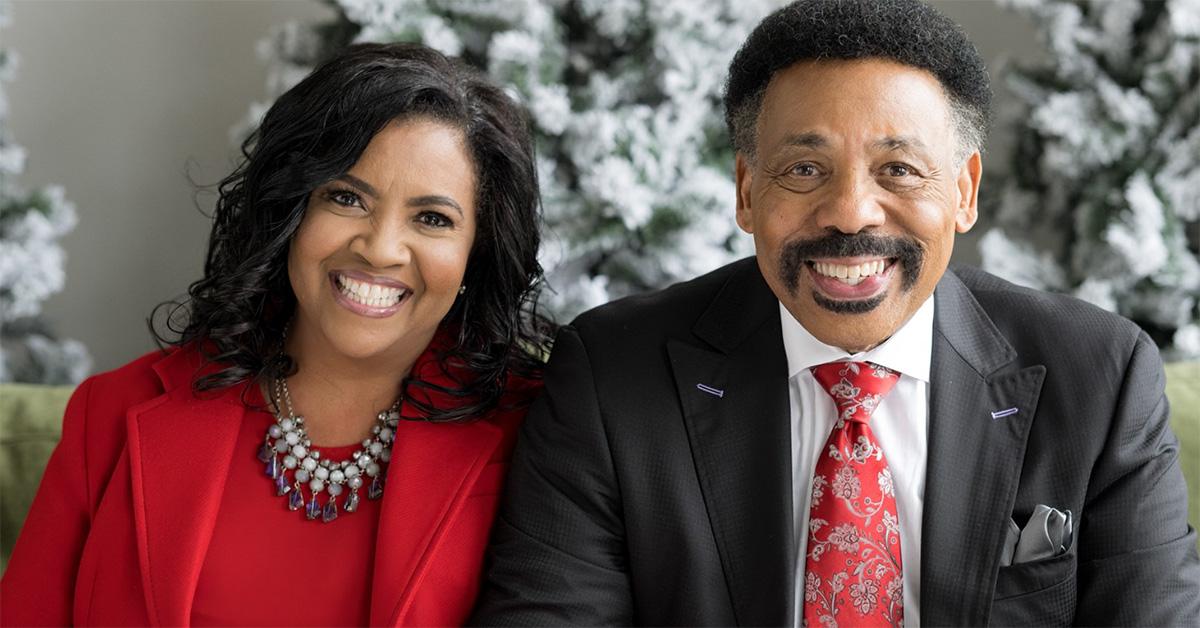 Tony Evans with his wife Carla in front of Christmas trees. 