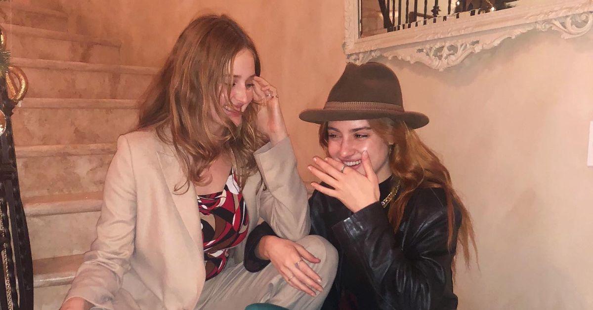 (l-r): Anna Van Patten and Grace Van Patten laughing on the stairs. 
