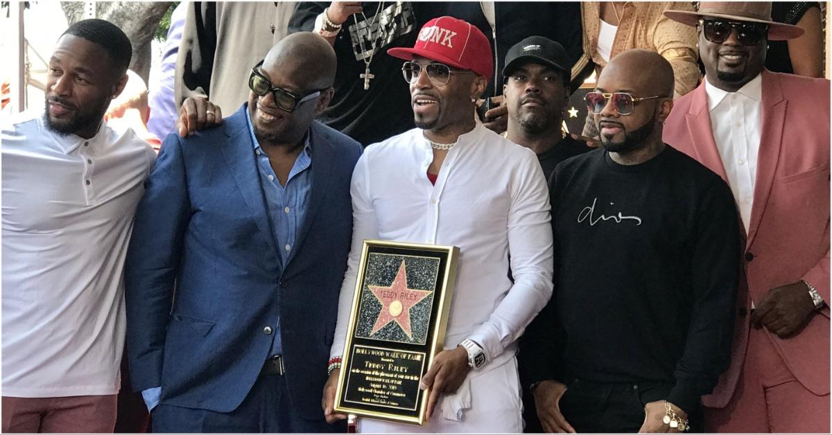 Andre Harrell posing with many others in the music industry