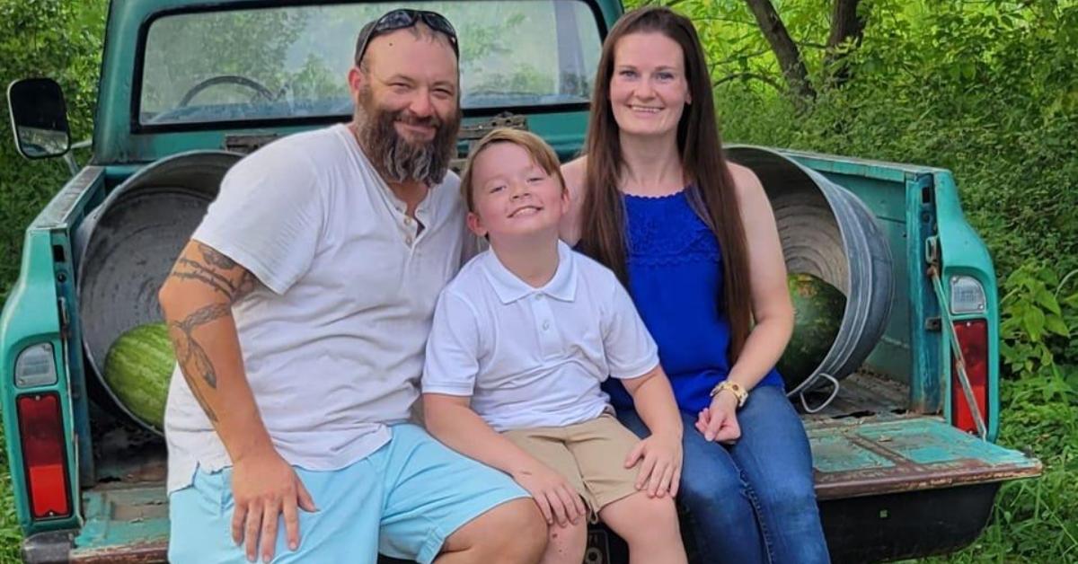 Thomas Jacob Sanford with his wife and son in the back of a truck.