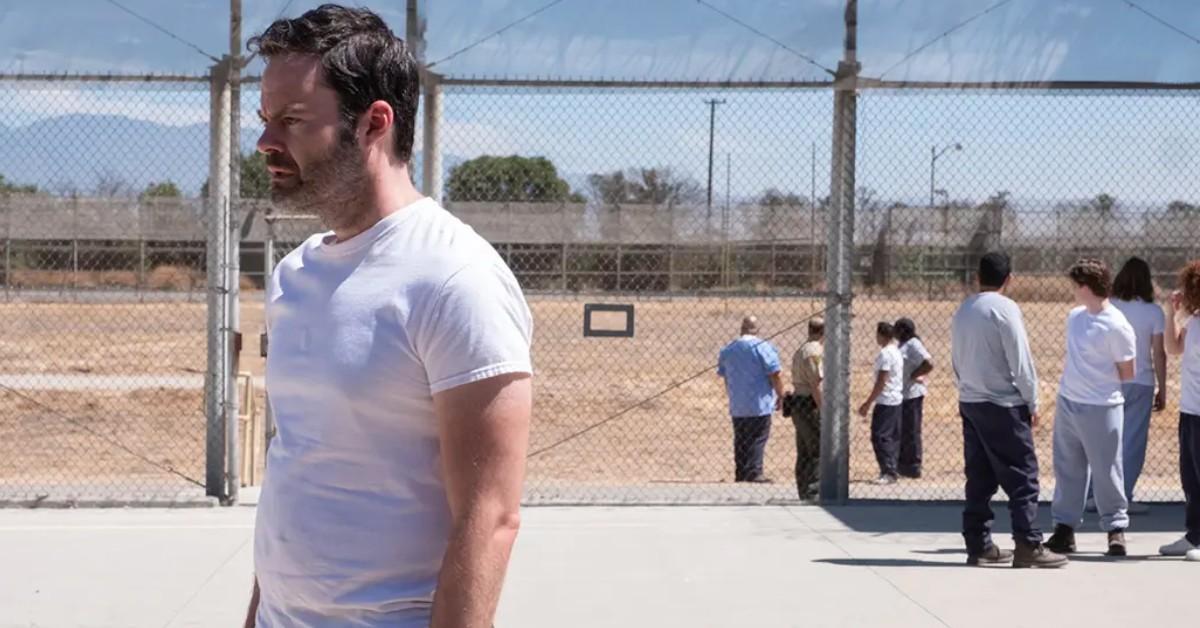 Barry (Bill Hader) in a white shirt, stands by himself in a prison courtyard. 