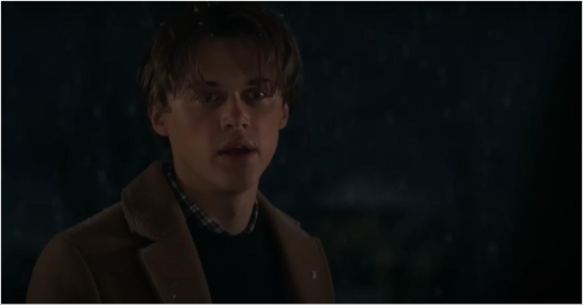 Conrad standing outside in the snow at Belly's door