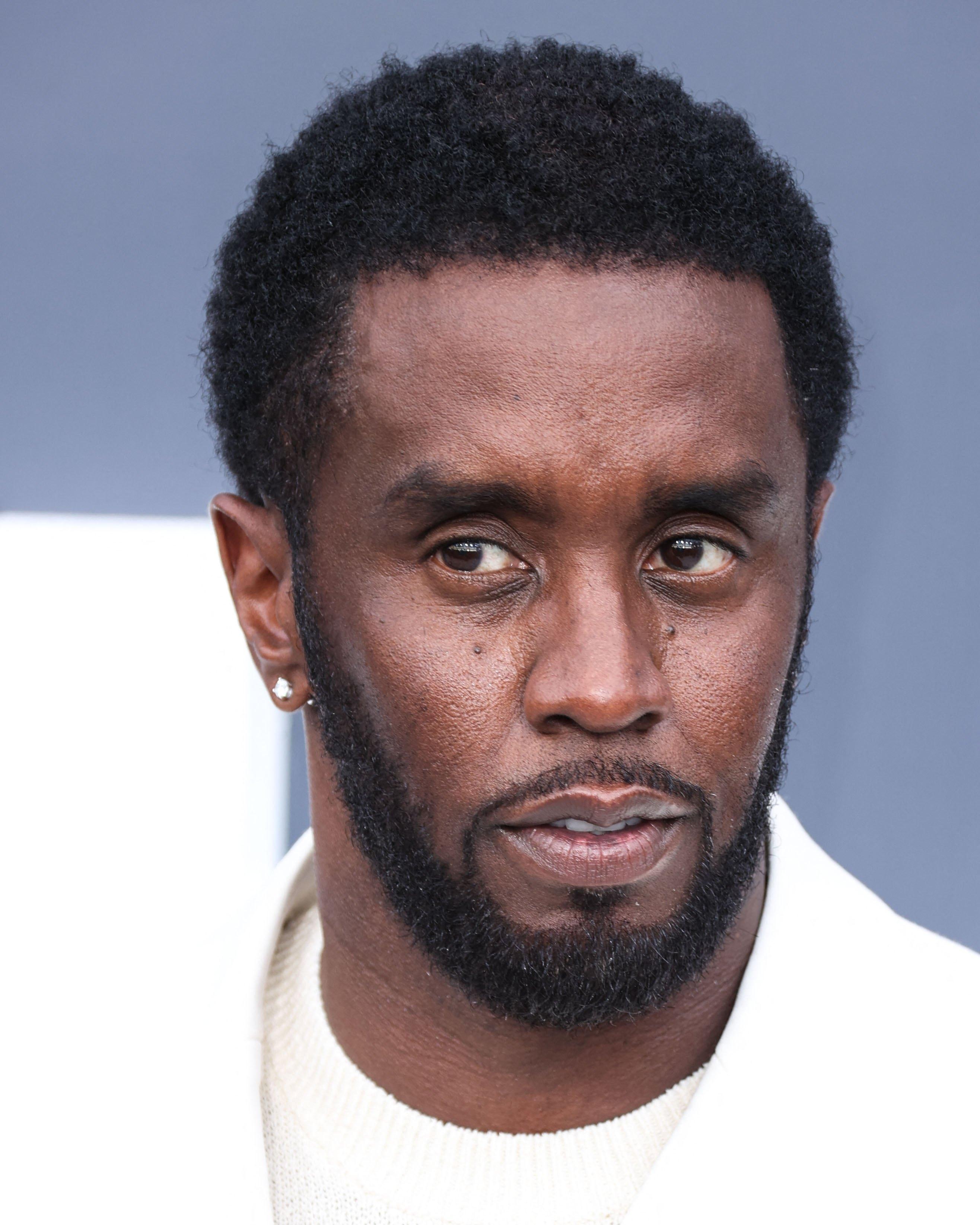 Diddy in all white at a Billboard event.