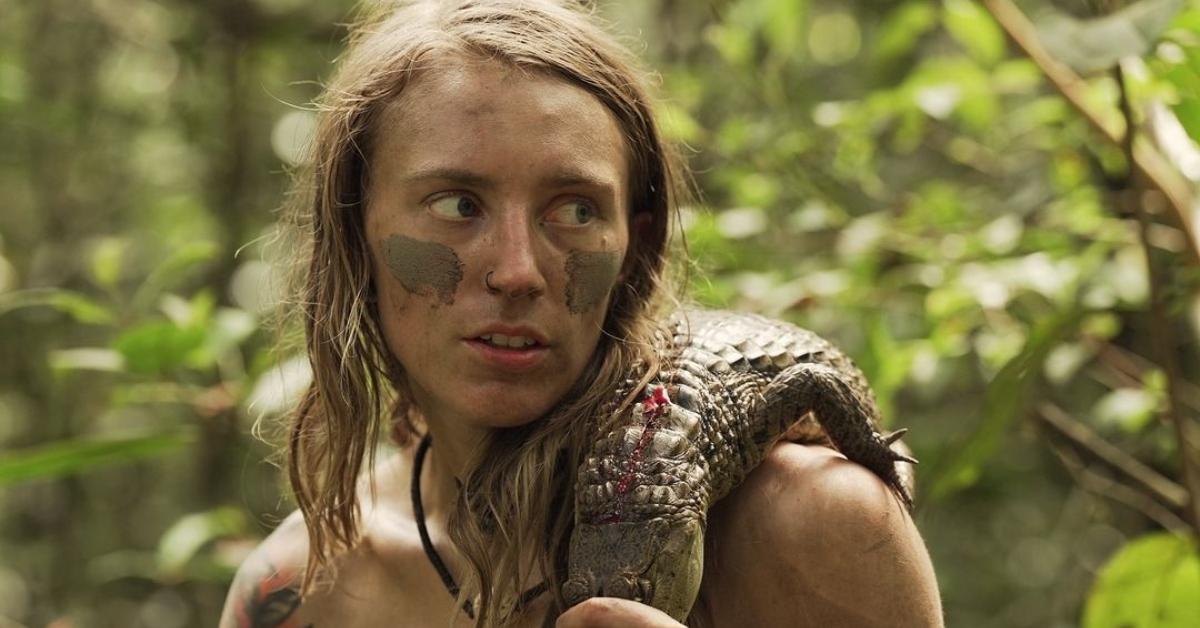 Kaiela Hobart with a caiman over her shoulder on Naked and Afraid XL