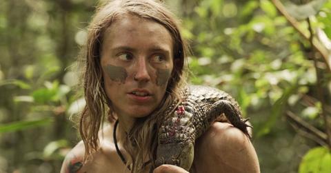 Kaiela Hobart with a caiman over her shoulder on Naked and Afraid XL