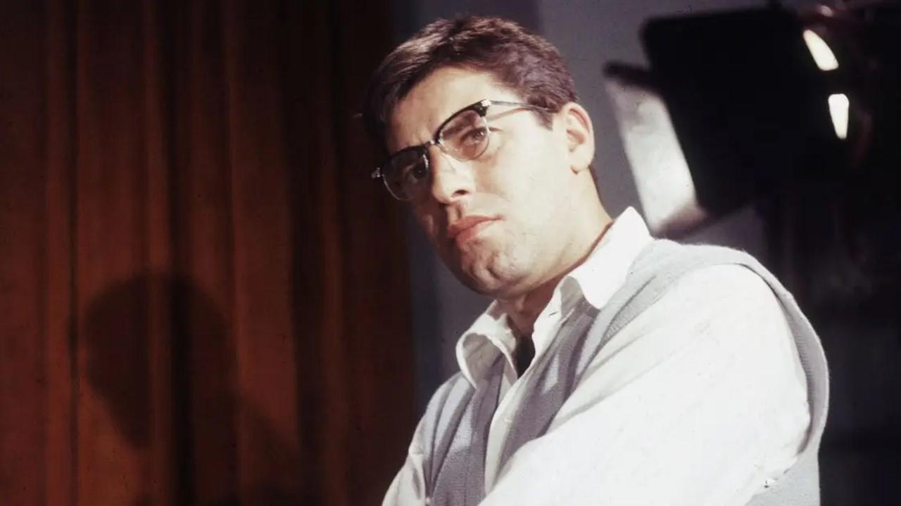  Jerry Lewis, wearing eyeglasses, standing with his arms crossed