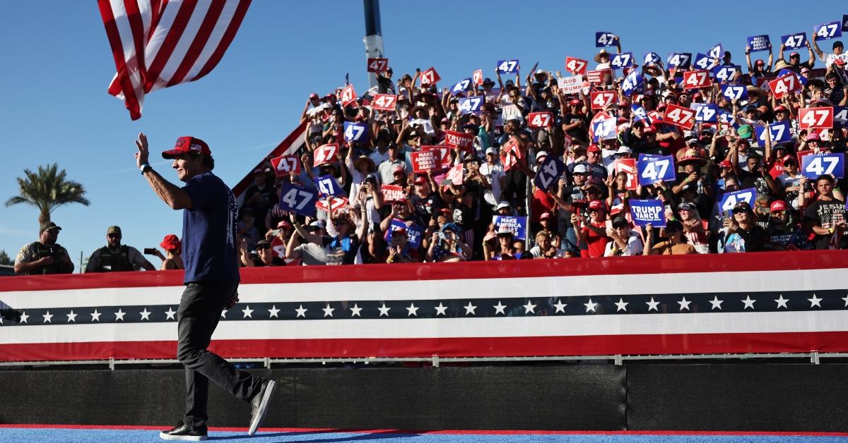 Actor Dennis Quaid walks across the stage at former President Donald Trump's Coachella campaign rally. 