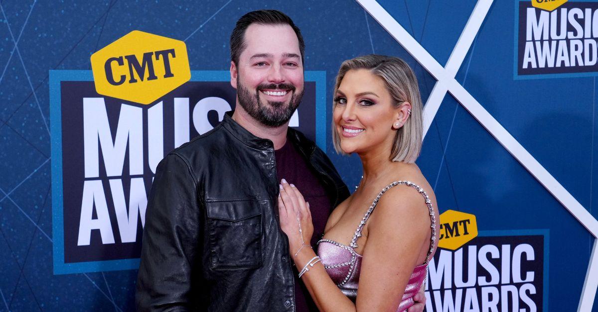 Travis Mullen and Gina Kirschenheiter pose for photo at the CMT awards red carpet