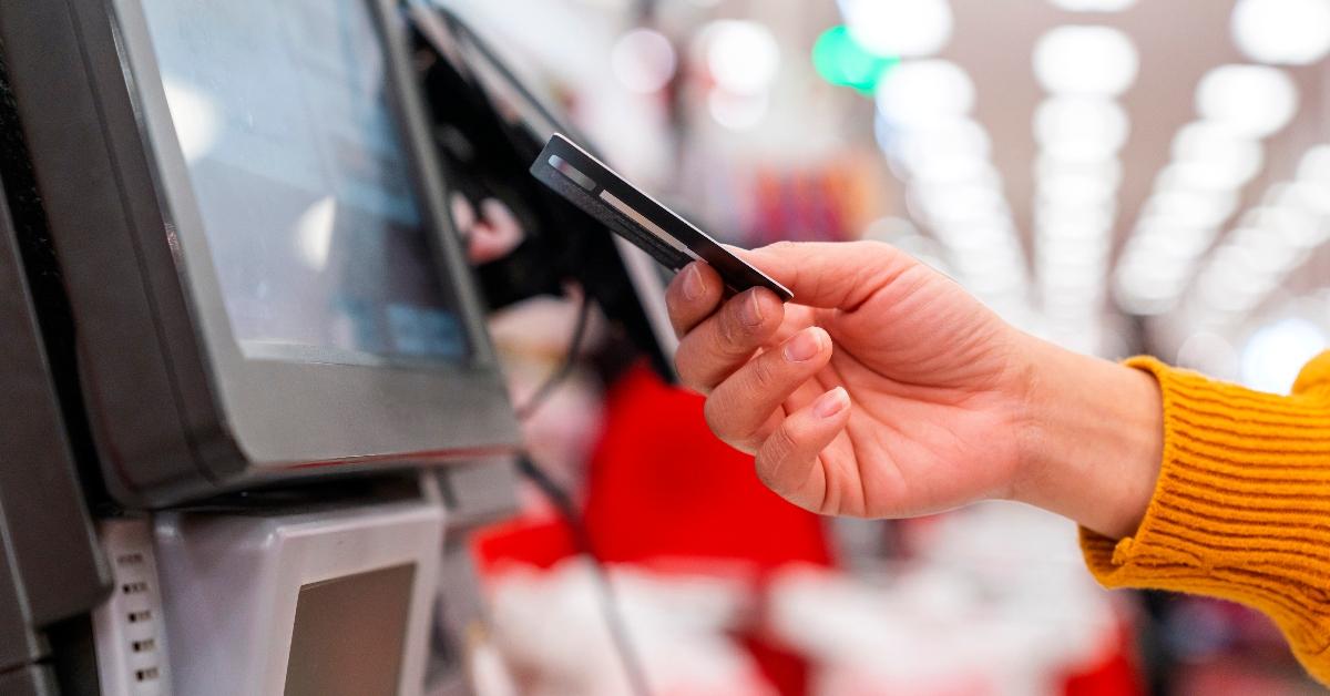 A woman pays using self-checkout