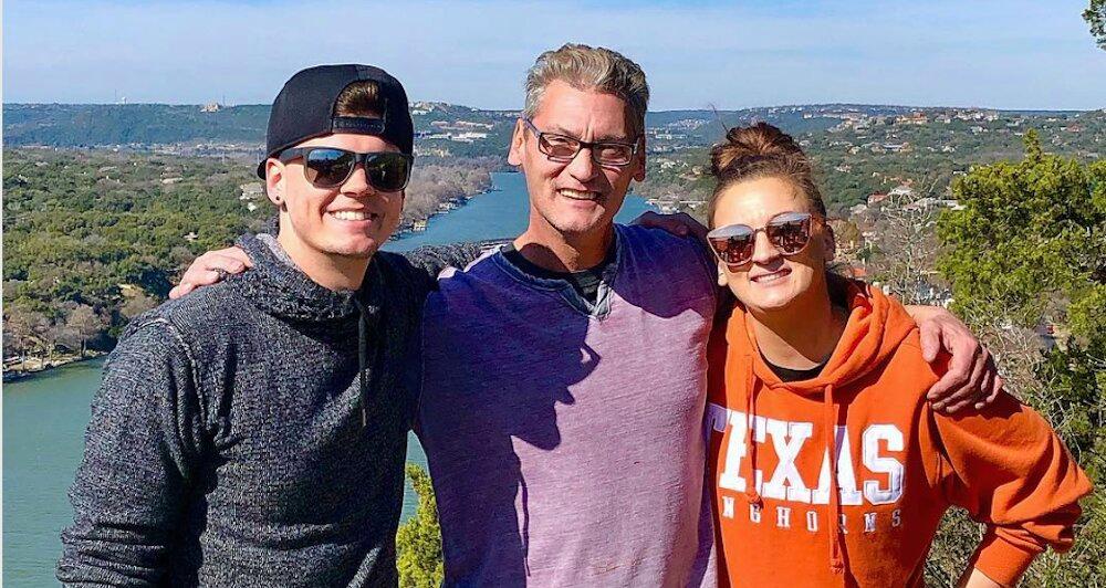 Tyler, Butch, and Amber Baltierra standing on a cliff.