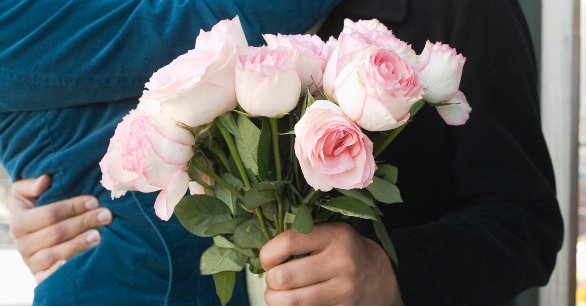 A couple with a bouquet of flowers.