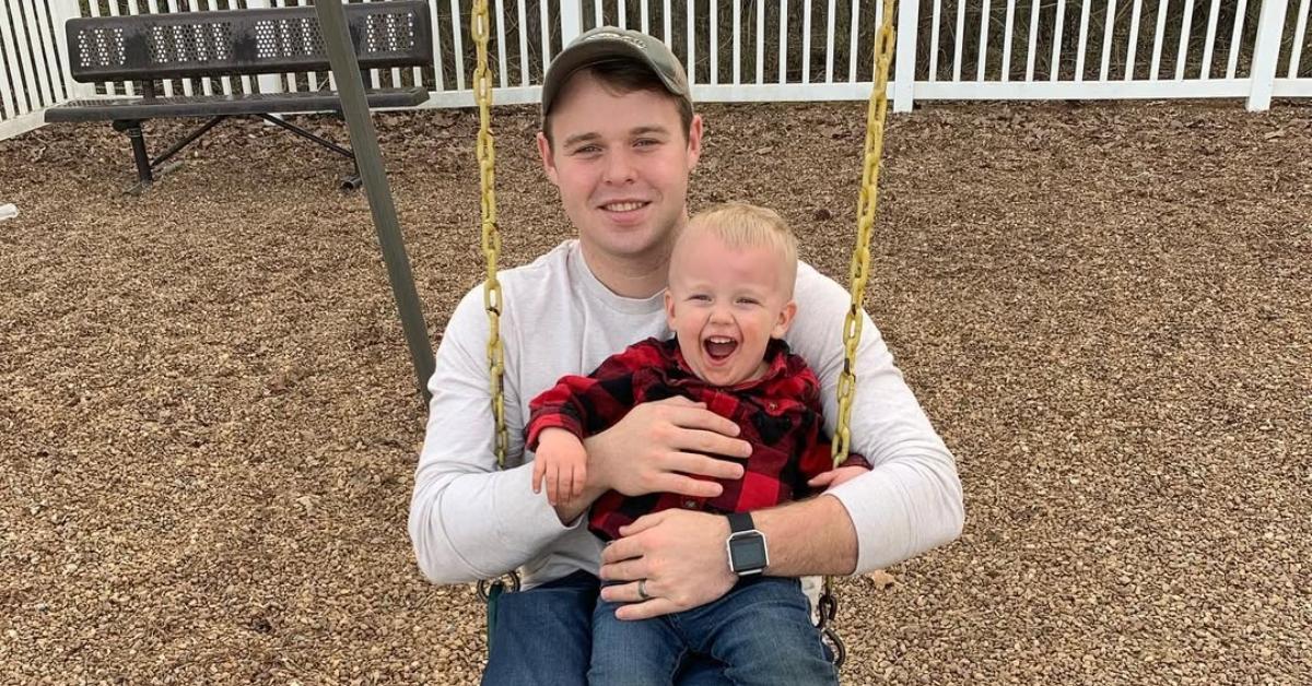 Joseph Duggar with his son on a swing.