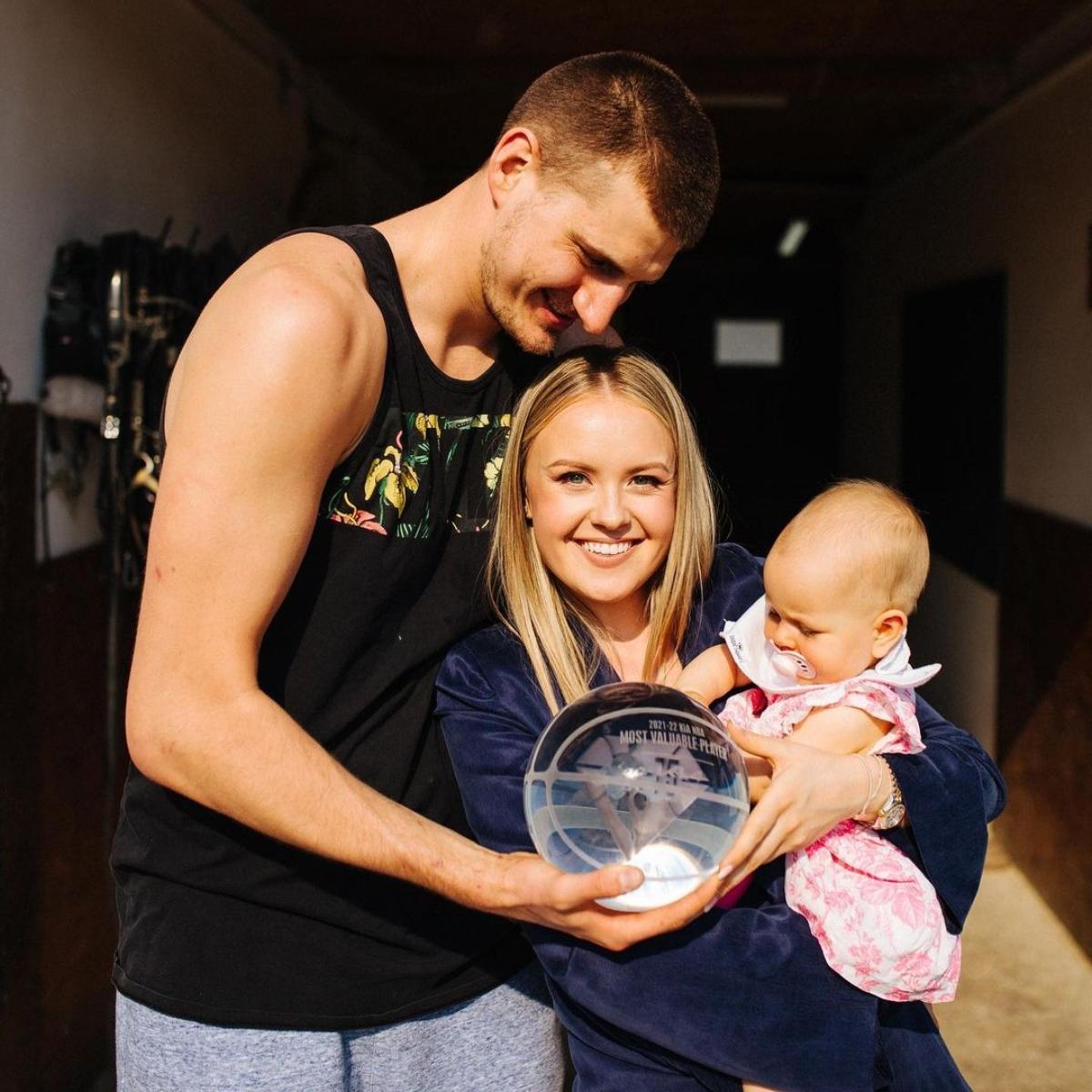 nikola jokić poses with wife and daughter.