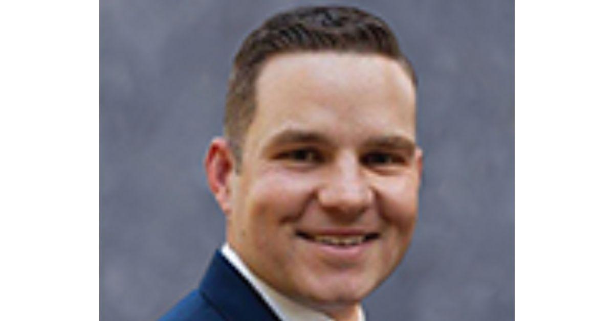 RJ May in a suit and tie. 