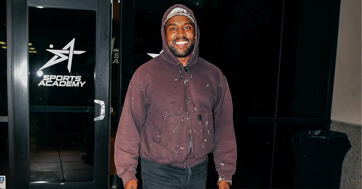 Kanye West flashes a smile.