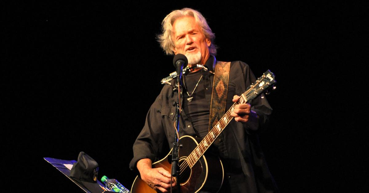 Kris Kristofferson performing on stage.