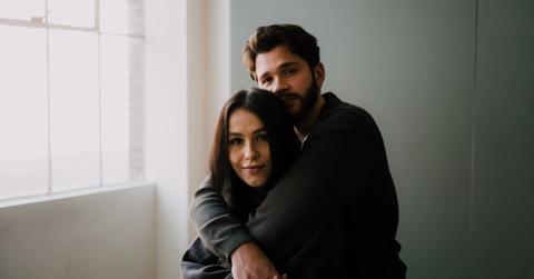 A man hugging a woman from behind