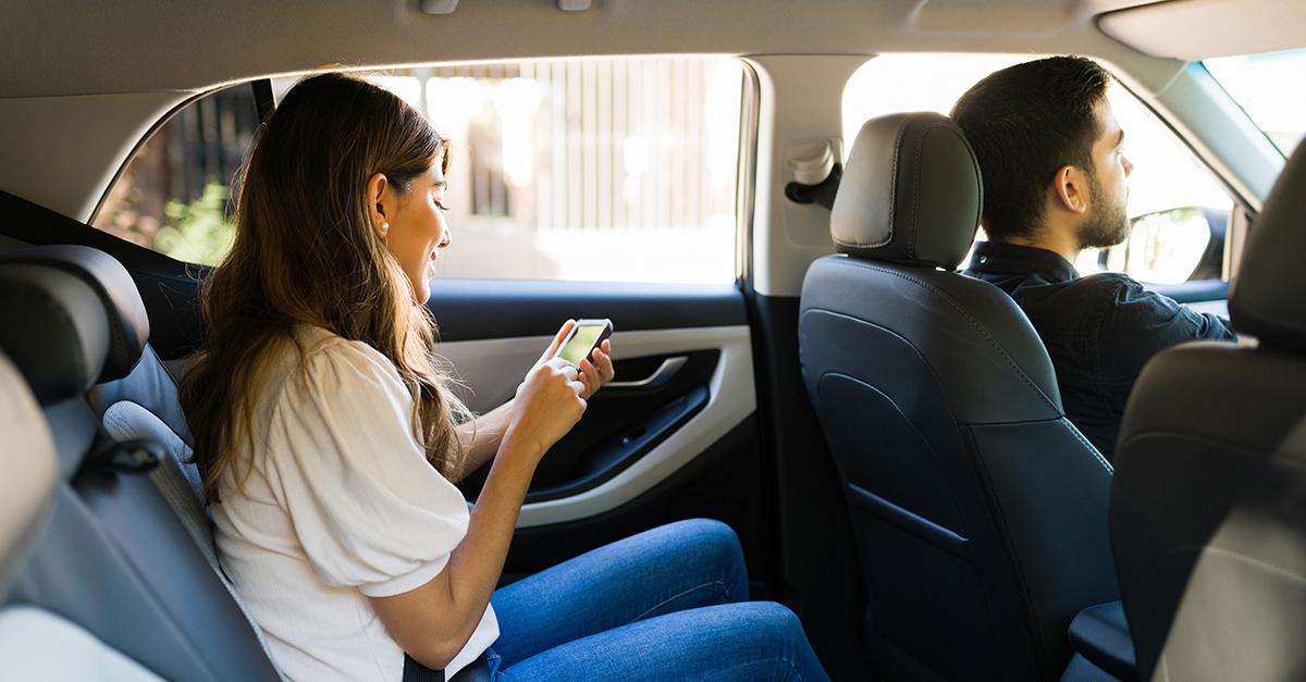 Woman on her phone in backseat of an Uber