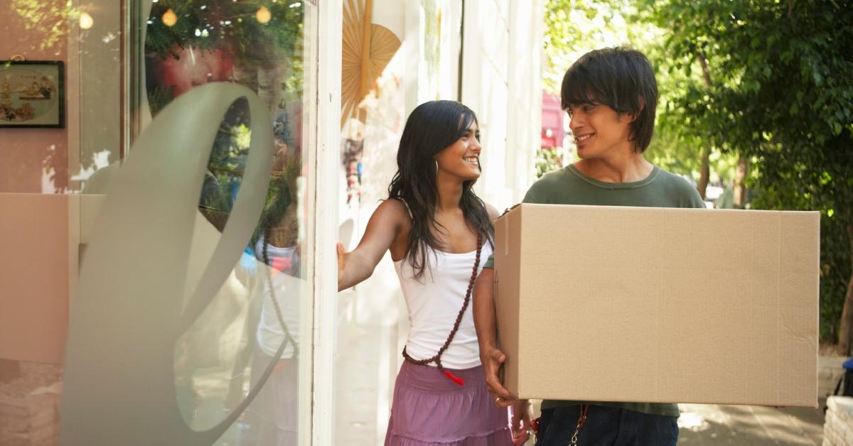 guy carrying box for girl