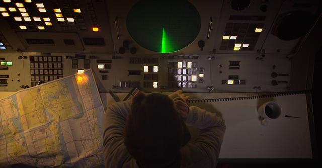 person looking at radar and map