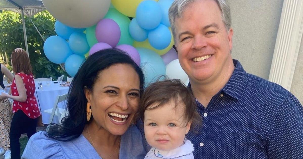 Kristen Welker with her husband and their daughter at a party.