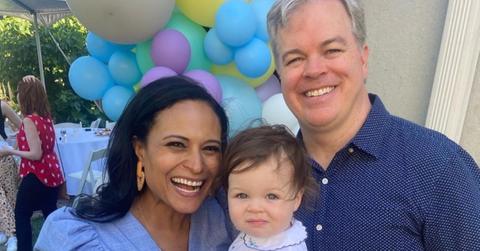 Kristen Welker with her husband and their daughter at a party.