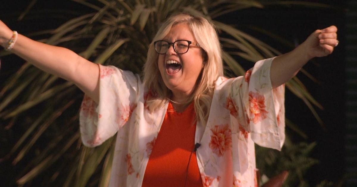 Angela Murray in a white and orange floral top outside on Big Brother