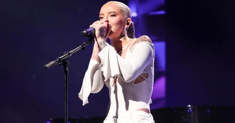 young miko performing onstage in white outfit