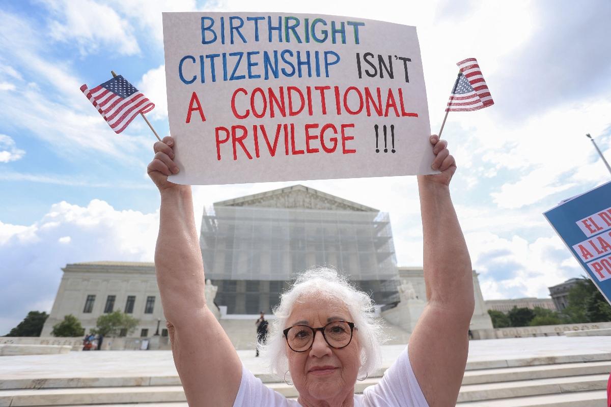 A woman protesting the end of birthright citizenship outside of the Supreme Court