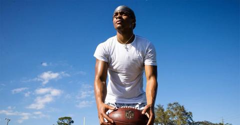 Justin Fields with a football in his hands from below.