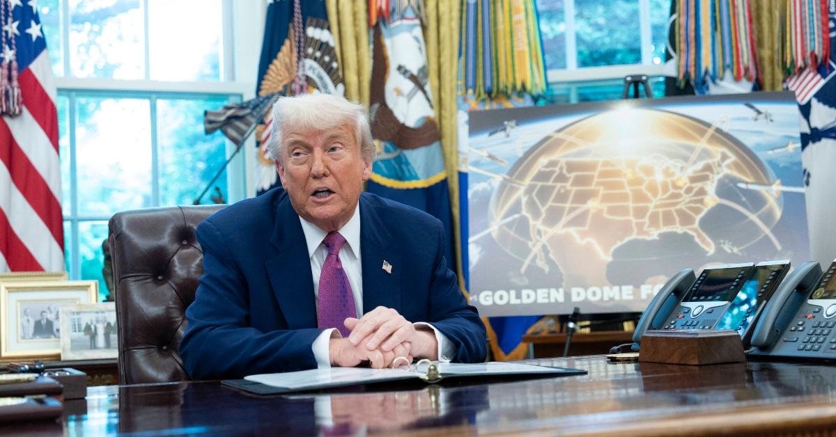Donald Trump sits in the Oval Office