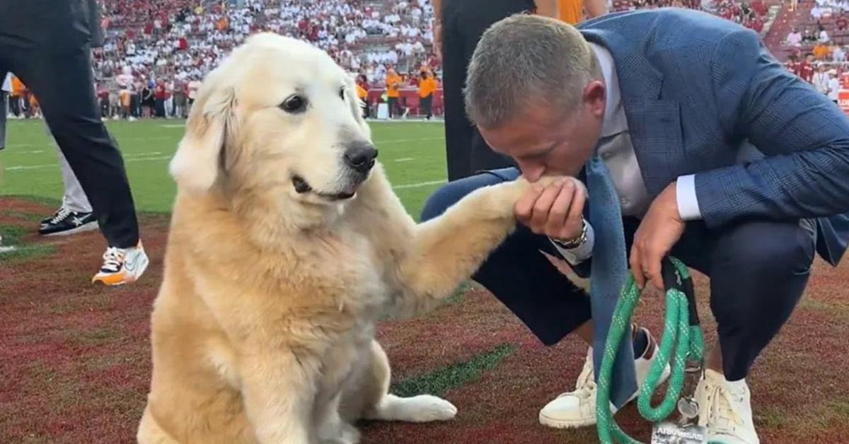 Kirk Herbstreit giving his dog a kiss.