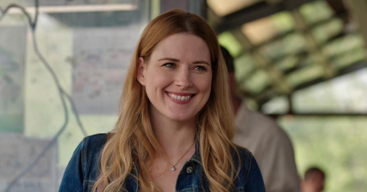 Alexandra Breckenridge as Mel Monroe smiling wearing a jean jacket in 'Virgin River'. 