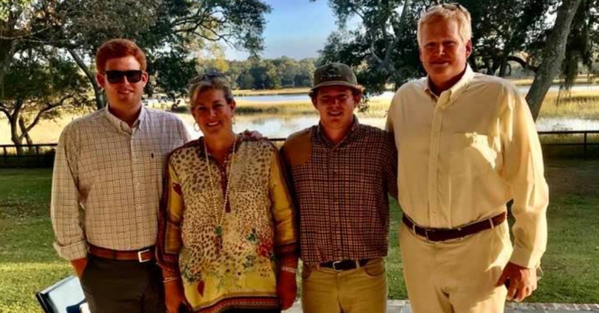 Buster, Maggie, Paul, and Alex Murdaugh pose for a photo outside by a lake.