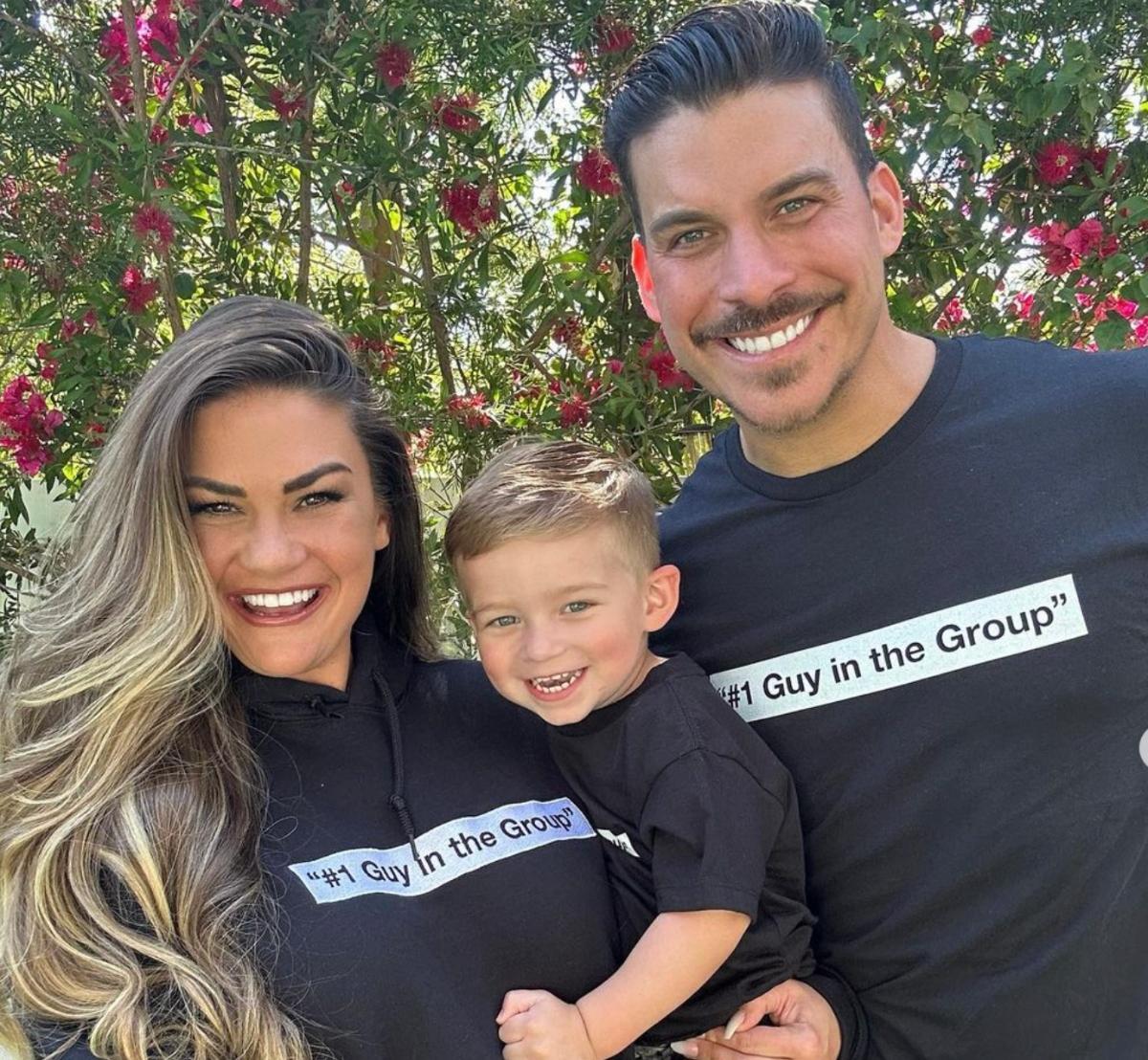 Brittany Cartwright and Jax Taylor with their son Cruz, wearing "#1 guy in the group" t-shirts