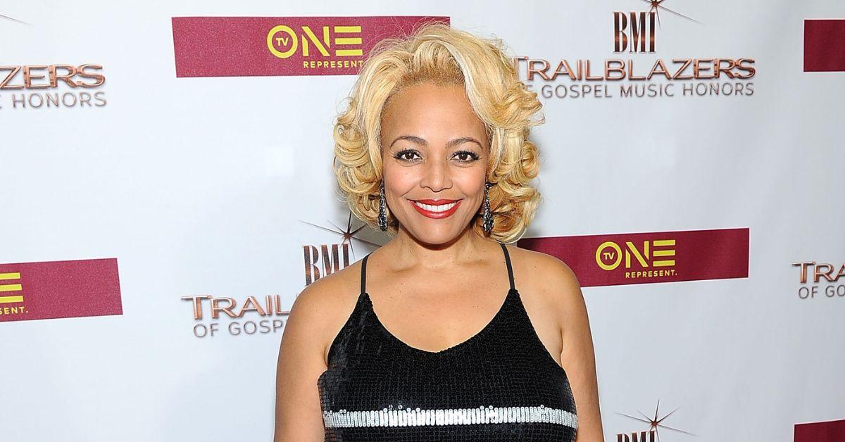 Kim Fields posing at a TV One event on the red carpet.