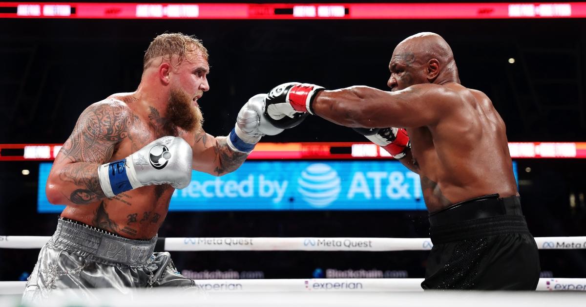 Jake Paul and Mike Tyson fighting in the ring.