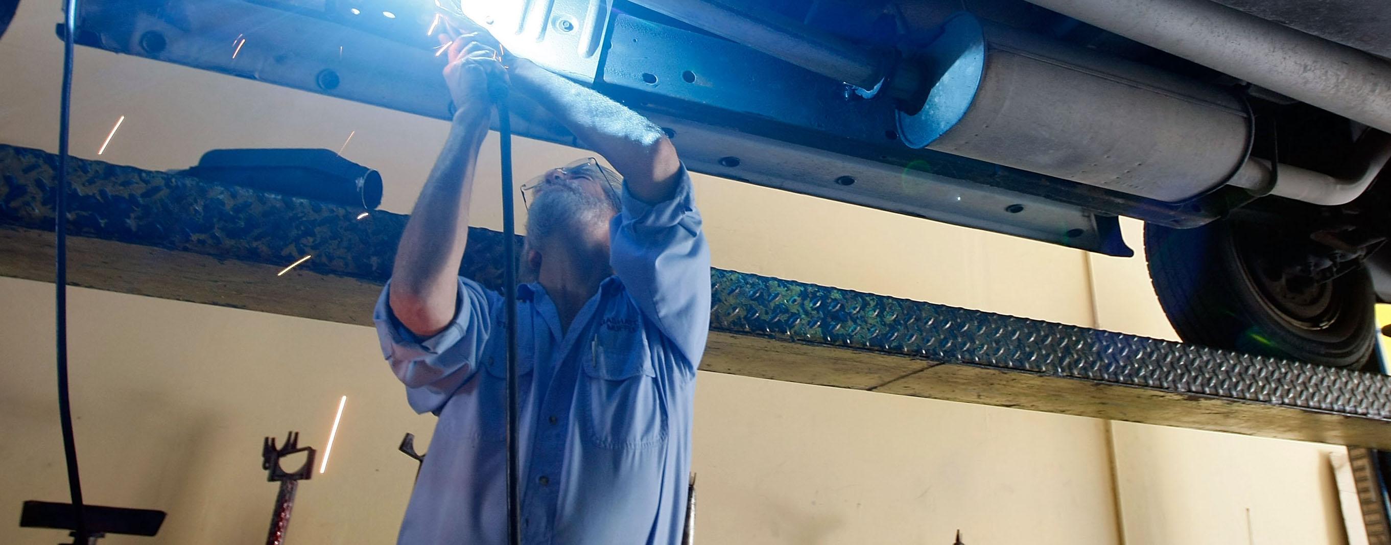 A Mechanic Working on a Vehicle