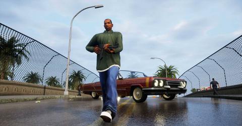 Screenshot of CJ with a gun on a street in 'GTA: San Andreas.'
