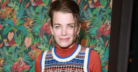 Julie Montagu poses for a photo in front of a colorful patterned wall