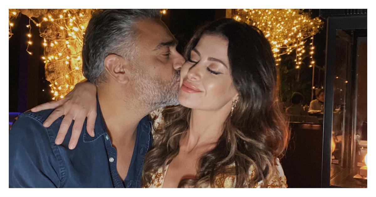 (l-r): Munaf Ali kissing his wife Nina Ali on the cheek. 