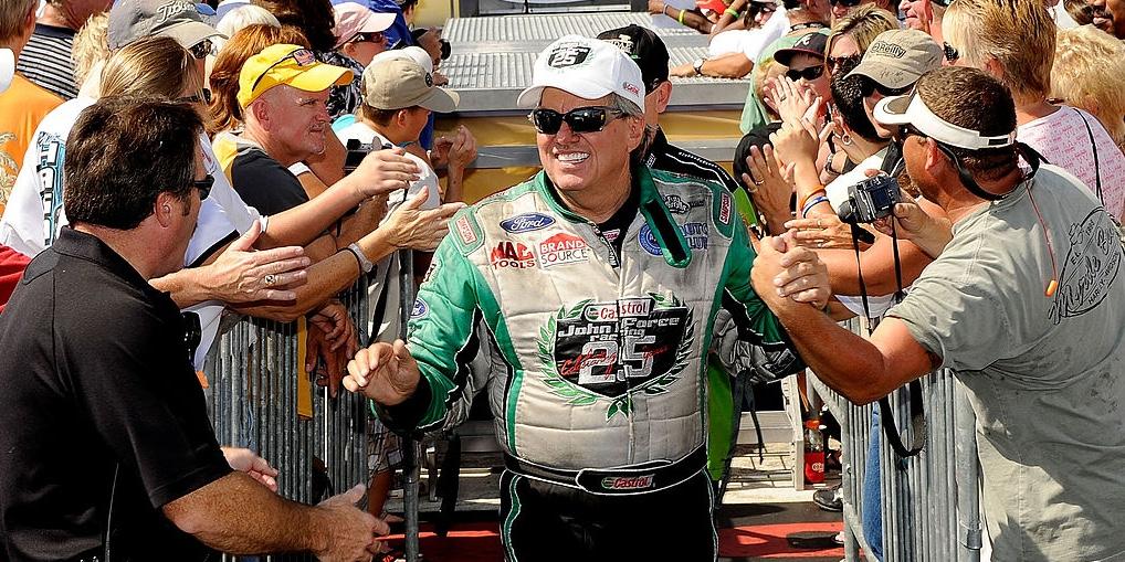 John Force shaking hands with people after a race