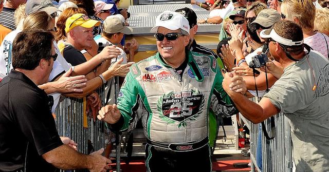 John Force shaking hands with people after a race